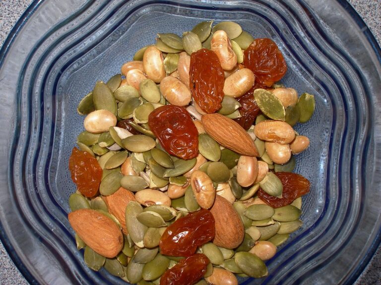 Blue bowl filled with mixed nuts, seeds and dried fruit