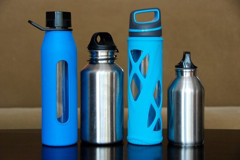 Reusable water bottles in blue and steel lined up on a table