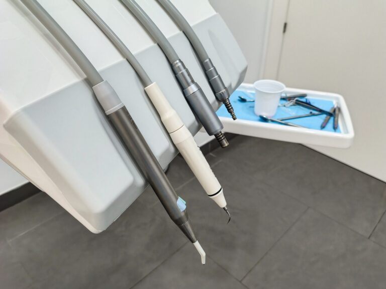 Clean dental instruments attached to a dental chair in a bright clinic