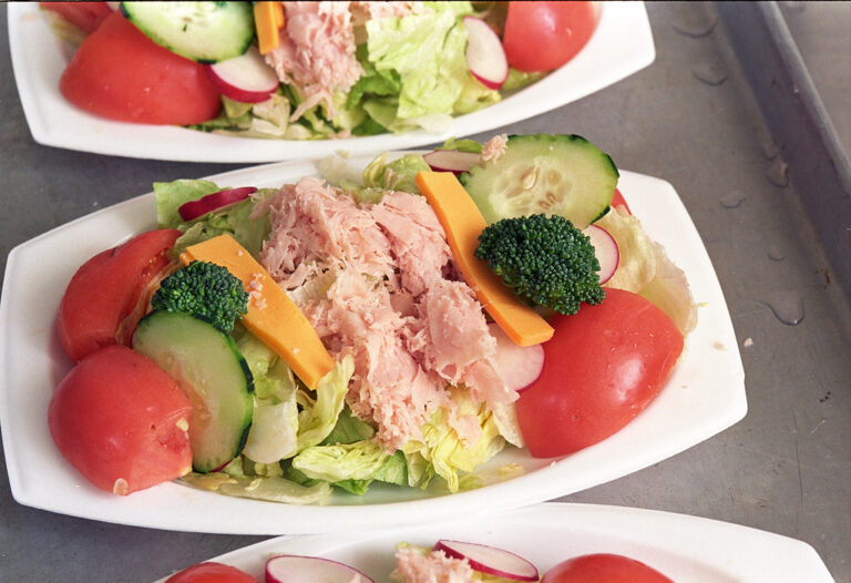 Fresh salad plates with tuna, tomatoes, cucumber, carrots and broccoli