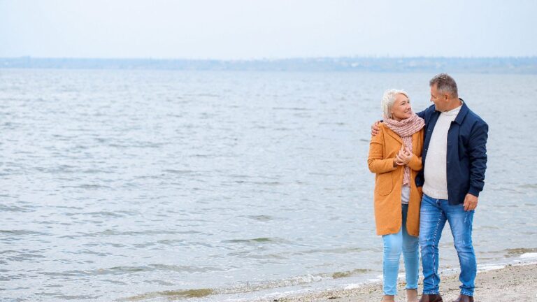 Older couple walking together outdoors to stay active and healthy after 60