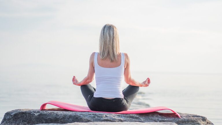 Adult sitting calmly at home and taking a slow, deep breath to manage everyday stress