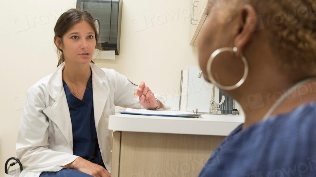 Doctor checking an adult patient's blood pressure during a routine preventive health checkup